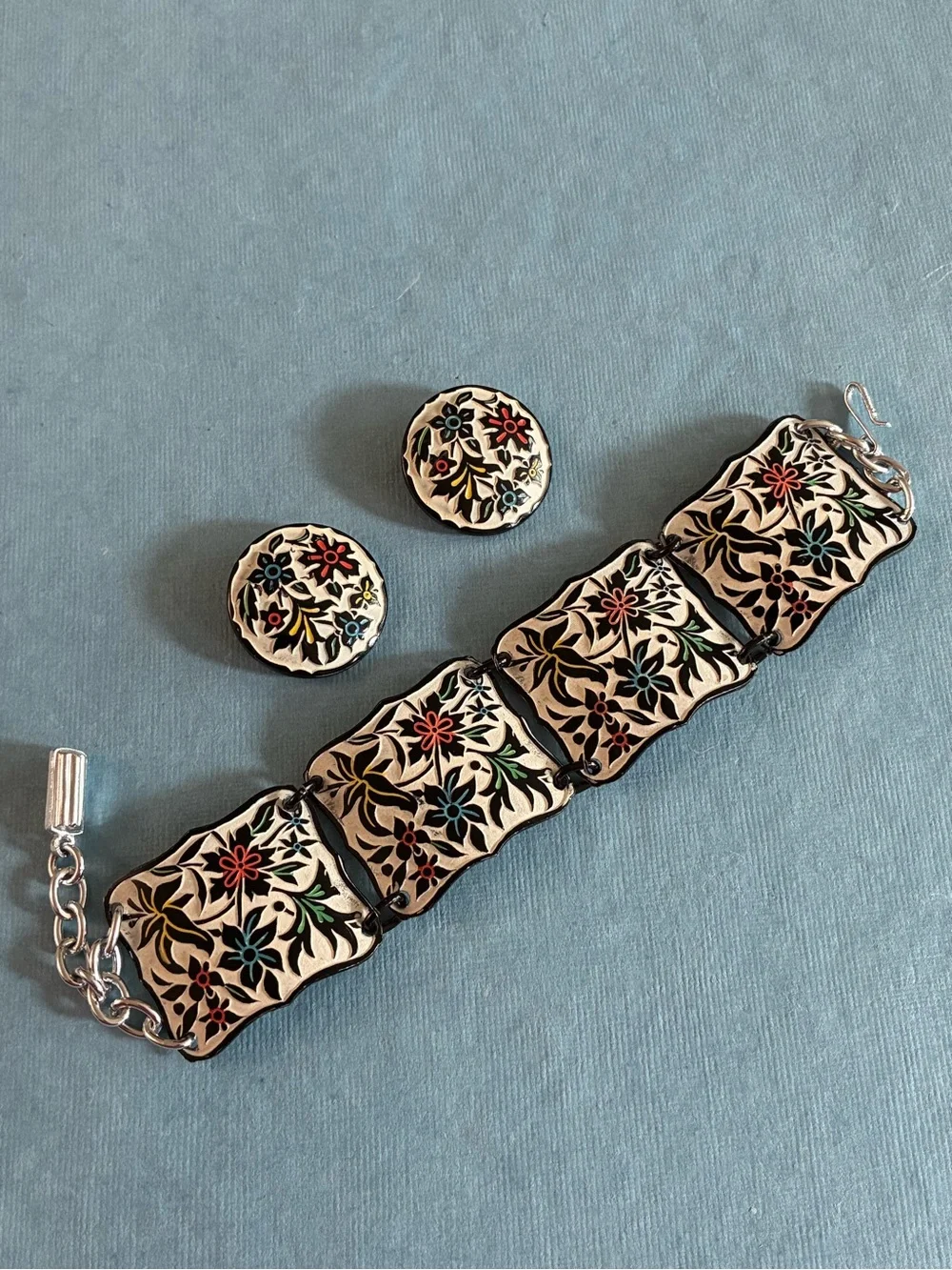 West Germany floral relief enameled bracelet and clip earrings set on beige